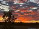 Sunset sky, a dramatic sky with hues of orange and gray highlighting a beautiful view over a landscape with silhouette of a tree at 196 W 8Th Ave, Byers, CO 80103