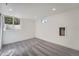 Finished basement with two windows, recessed lighting, and neutral gray carpet at 8463 W Arizona Dr, Lakewood, CO 80232
