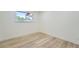 Finished basement with modern wood floors and natural light from the egress window at 8463 W Arizona Dr, Lakewood, CO 80232