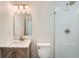 Modern bathroom features an updated vanity, stylish mirror, and a glass walk-in shower at 8463 W Arizona Dr, Lakewood, CO 80232
