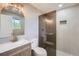 Modern bathroom with walk-in shower, updated vanity, and stylish lighting at 8463 W Arizona Dr, Lakewood, CO 80232