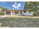 Charming single story home featuring a well-kept lawn, a covered porch, and attached garage at 8463 W Arizona Dr, Lakewood, CO 80232