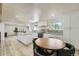 This bright kitchen features a center island, modern appliances, and a cozy dining area at 8463 W Arizona Dr, Lakewood, CO 80232
