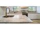 Close-up of the kitchen counter featuring white cabinets and stainless-steel appliances at 8463 W Arizona Dr, Lakewood, CO 80232