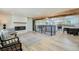 Bright living room showcases hardwood floors, wooden beams, a fireplace, and an open floor plan at 8463 W Arizona Dr, Lakewood, CO 80232