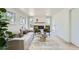 Bright living room with fireplace, modern furniture, and hardwood floors at 8463 W Arizona Dr, Lakewood, CO 80232