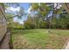 Backyard with green grass, stone fire pit and mature trees provides privacy at 2921 S Holly Pl, Denver, CO 80222