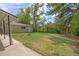 View of backyard with detached garage, grassy lawn, and built in fire pit at 2921 S Holly Pl, Denver, CO 80222