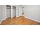 This bedroom features wood floors, light grey walls and two closets at 2921 S Holly Pl, Denver, CO 80222