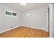 Empty bedroom with hardwood floors, two windows and closet access at 2921 S Holly Pl, Denver, CO 80222