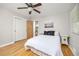 Bedroom featuring hardwood floors, ceiling fan, closet and view of the kitchen at 2921 S Holly Pl, Denver, CO 80222
