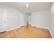 Empty bedroom featuring hardwood floors, neutral paint, and closet access at 2921 S Holly Pl, Denver, CO 80222