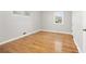 Empty bedroom with hardwood floors, large windows and baseboard heaters at 2921 S Holly Pl, Denver, CO 80222
