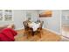 Dining area with a wooden table, four chairs, and natural lighting at 2921 S Holly Pl, Denver, CO 80222