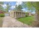 Side view of a home with a detached garage and a driveway at 2921 S Holly Pl, Denver, CO 80222
