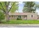 Charming single-story home featuring a well-maintained lawn and mature trees at 2921 S Holly Pl, Denver, CO 80222