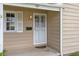 A close-up of the front door featuring a screen door and decorative details at 2921 S Holly Pl, Denver, CO 80222