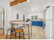Bright kitchen with white cabinets, an eat-in counter, and colorful blue accents at 2921 S Holly Pl, Denver, CO 80222