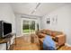 Cozy living room with hardwood floors, slider to backyard and comfortable seating at 2921 S Holly Pl, Denver, CO 80222