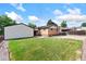 Backyard with manicured lawn, detached garage, brick siding, and a spacious driveway at 10949 E 109Th Pl, Northglenn, CO 80233