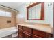 Updated bathroom features a tiled shower over tub, a vanity, and a mirror cabinet at 10949 E 109Th Pl, Northglenn, CO 80233