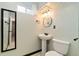 Small bathroom featuring classic black and white tile, pedestal sink, and updated lighting at 10949 E 109Th Pl, Northglenn, CO 80233