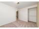 Bright carpeted bedroom featuring an open closet, and neutral walls and carpets at 10949 E 109Th Pl, Northglenn, CO 80233