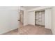 Bright carpeted bedroom featuring an open closet, and neutral walls and carpets at 10949 E 109Th Pl, Northglenn, CO 80233
