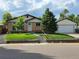 Charming brick home with a well-manicured front yard and a detached two-car garage at 10949 E 109Th Pl, Northglenn, CO 80233