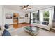 Bright living room with hardwood floors, modern furniture, and large windows with gray curtains at 10949 E 109Th Pl, Northglenn, CO 80233