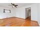 Bright living room with hardwood floors and a view into the hallway at 10949 E 109Th Pl, Northglenn, CO 80233