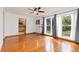 Spacious living room featuring shiny hardwood floors and three windows with lots of natural light at 10949 E 109Th Pl, Northglenn, CO 80233