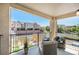 Relaxing balcony with seating area and black metal railings overlooking neighborhood streets and neighboring townhomes at 1044 Rockhurst Dr # 207, Highlands Ranch, CO 80129