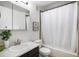 Bathroom with modern vanity, tub-shower combo with white curtain, and decorative art at 1044 Rockhurst Dr # 207, Highlands Ranch, CO 80129