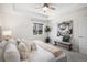 Bright bedroom featuring a ceiling fan, neutral tones, and modern decor at 1044 Rockhurst Dr # 207, Highlands Ranch, CO 80129