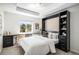 Bedroom features a Murphy bed, a built-in desk, and a shelving unit creating a multi-functional space at 1044 Rockhurst Dr # 207, Highlands Ranch, CO 80129