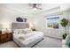 A cozy bedroom with a stylish headboard, ceiling fan, and a neutral color scheme at 1044 Rockhurst Dr # 207, Highlands Ranch, CO 80129