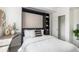 Bedroom features a Murphy bed, built-in desk, shelving unit, and closet, maximizing space and functionality at 1044 Rockhurst Dr # 207, Highlands Ranch, CO 80129