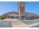 A street view of a shopping center, featuring a prominent brick clock tower and various storefronts at 1044 Rockhurst Dr # 207, Highlands Ranch, CO 80129