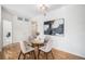 Bright dining area with a glass table, stylish chairs, and an abstract art piece at 1044 Rockhurst Dr # 207, Highlands Ranch, CO 80129