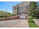 Exterior view of condo showing private garage, driveway, and well-manicured landscaping at 1044 Rockhurst Dr # 207, Highlands Ranch, CO 80129