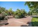 A park area with lush trees, flower beds, and steps with railing leading up the hill at 1044 Rockhurst Dr # 207, Highlands Ranch, CO 80129