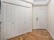 Bright hallway featuring wood floors, ample closet space, and neutral paint at 1044 Rockhurst Dr # 207, Highlands Ranch, CO 80129