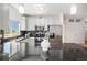 Modern kitchen featuring white cabinets, granite countertops, and stainless steel appliances at 1044 Rockhurst Dr # 207, Highlands Ranch, CO 80129