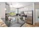 Bright kitchen features light cabinets, black countertops, and stainless steel appliances at 1044 Rockhurst Dr # 207, Highlands Ranch, CO 80129