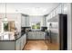 A well-lit kitchen with stainless steel appliances, and dark backsplash at 1044 Rockhurst Dr # 207, Highlands Ranch, CO 80129
