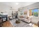 Cozy living room with modern fireplace, plush seating, and balcony access at 1044 Rockhurst Dr # 207, Highlands Ranch, CO 80129
