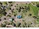 Aerial view of a green-roofed house nestled in a wooded lot at 12135 Cochise Cir, Conifer, CO 80433