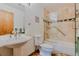 A clean bathroom featuring tile flooring, a walk in shower with glass doors and a pedestal sink at 12135 Cochise Cir, Conifer, CO 80433