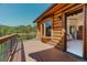 Exterior deck with log cabin walls, window, mountain views and bedroom access at 12135 Cochise Cir, Conifer, CO 80433
